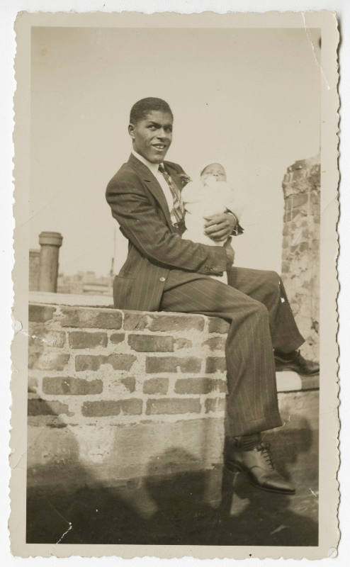 [Man holding a baby]