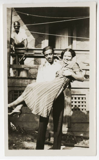[Young couple in front of a house]