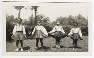 [Four young girls in matching outfits]