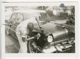 [Man washing a 1953 Lincoln]
