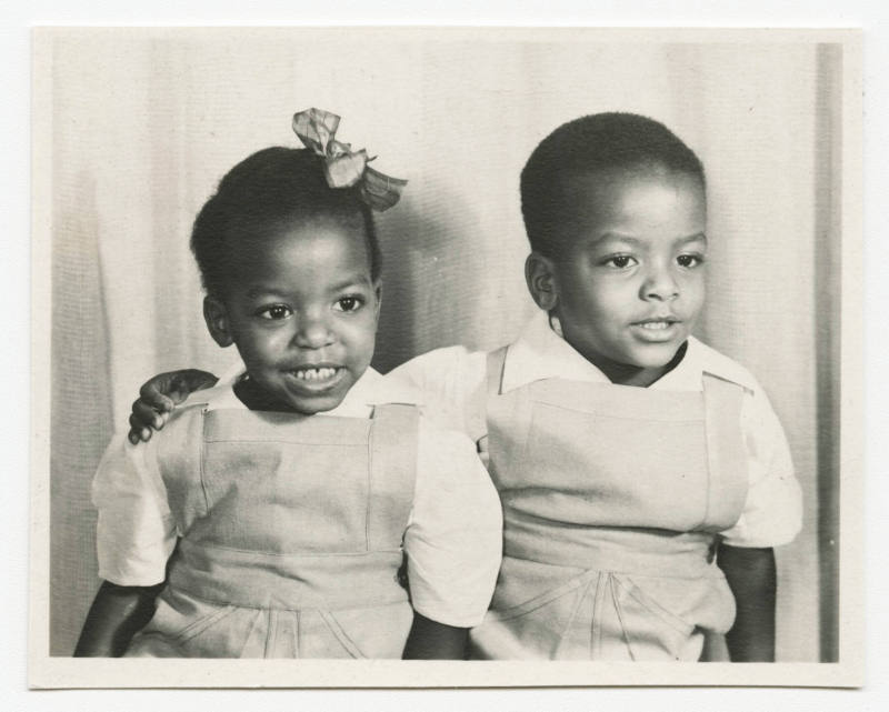 [Young girl and boy in matching outfits]