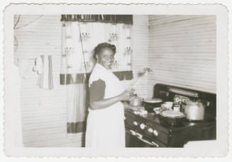 [Woman cooking in kitchen, Meridian, MS]