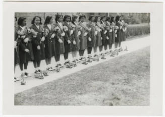 [Group of young women standing in a line]