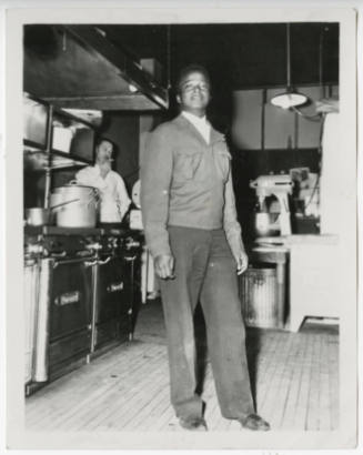 [Young man standing in a kitchen, Denver]