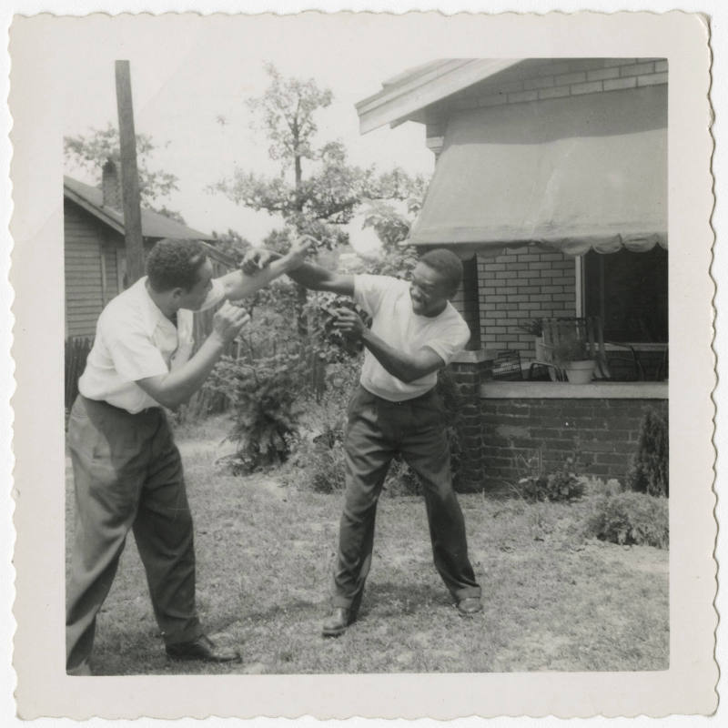 [Two men in front of a house, Birmingham]