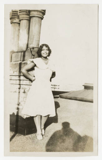 [Woman standing on rooftop]