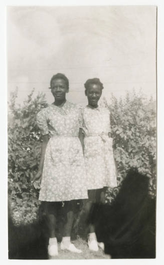 [Two young women standing outdside]