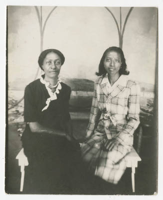 [Two women seated in a studio]