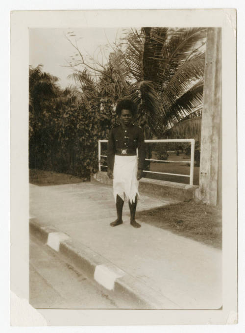 [Fijian police officer in uniform]