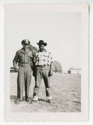 [Two men standing outdoors]