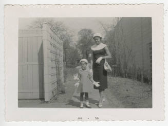 [Woman and child on a sidewalk]