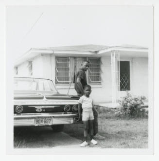 [Young man and young boy leaning on a Chevrolet, New Jersey]