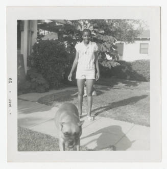 [Girl and dogs in front of a house]