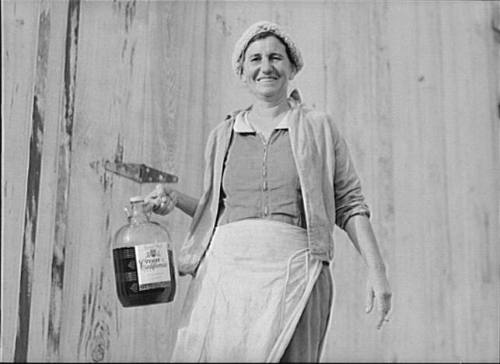 Spanish Muskrat Trapper's Wife with Gallon of Red Wine, Delacroix Island, Saint Bernard Parish, Louisiana