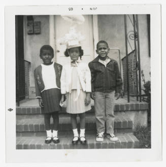 [Three children standing on steps]