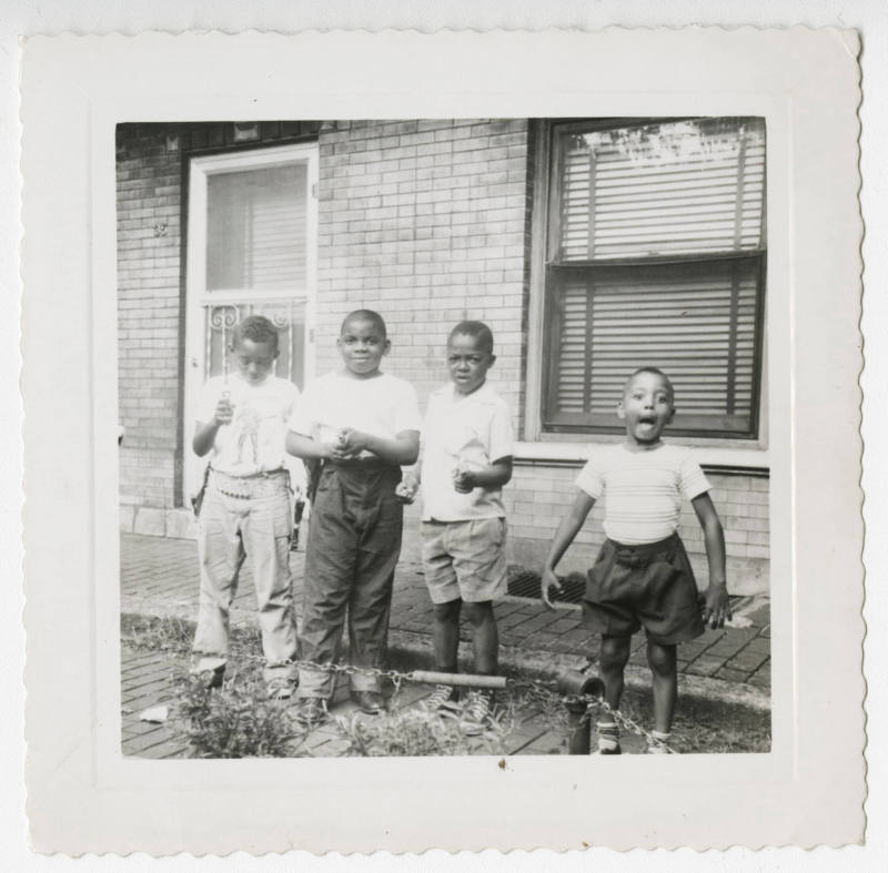 [Four boys standing outside]