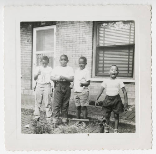 [Four boys standing outside]