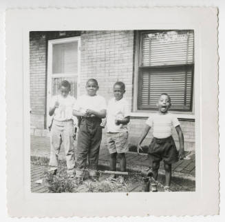 [Four boys standing outside]