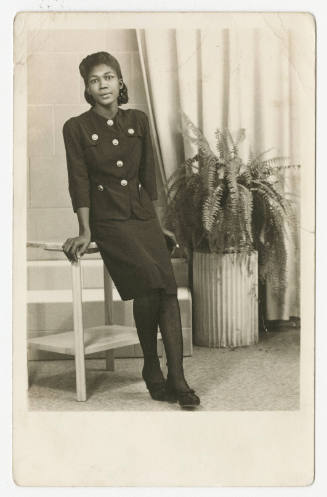 [Woman leaning against a table in a studio, Seguin, TX]