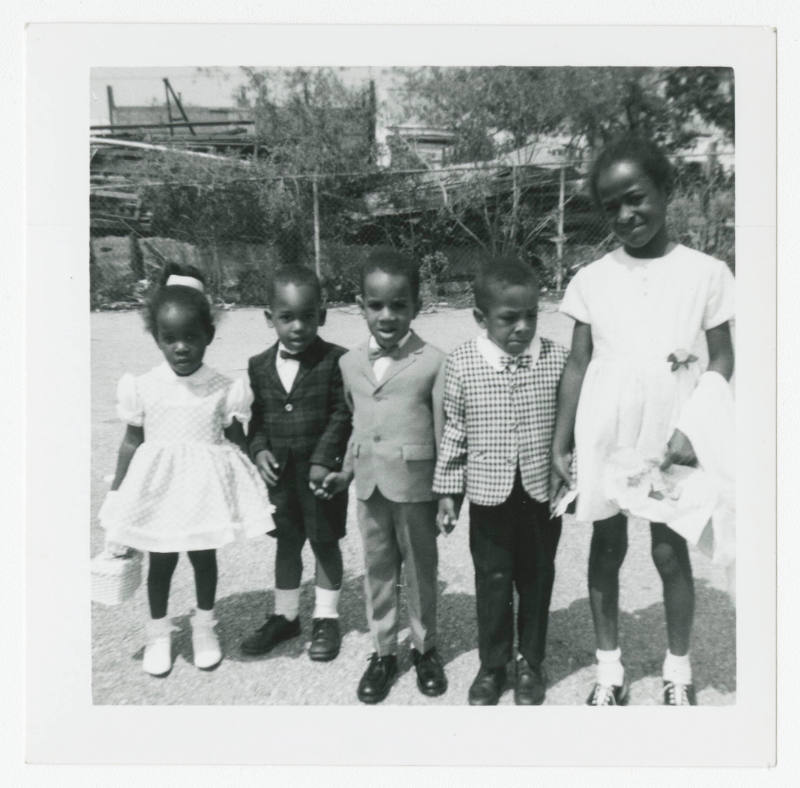[Five children standing outside]