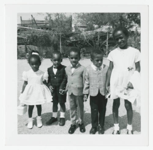 [Five children standing outside]
