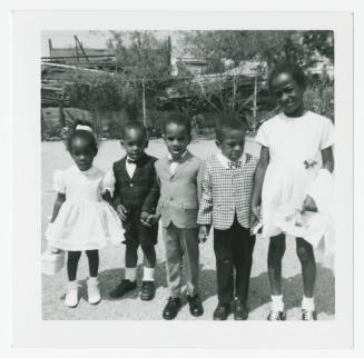 [Five children standing outside]