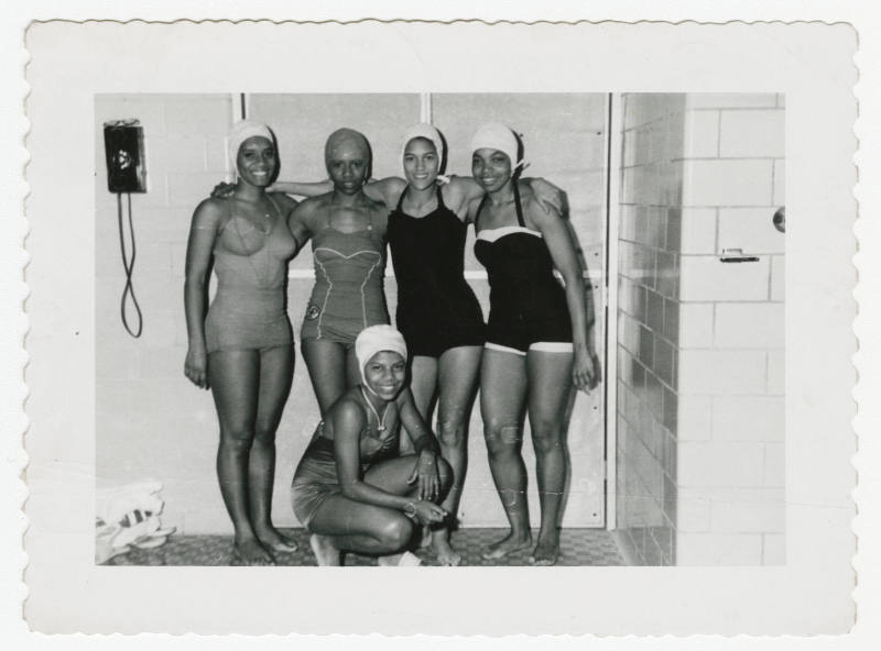 [Five women wearing swimsuits indoors]