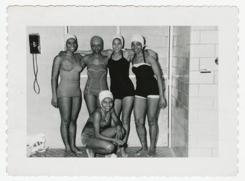 [Five women wearing swimsuits indoors]