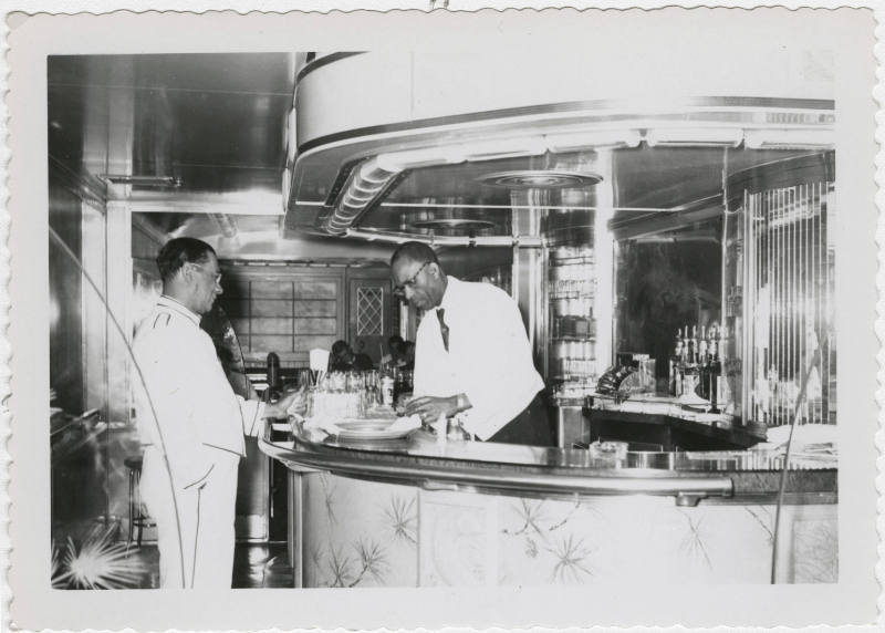 [Two men working in a bar]