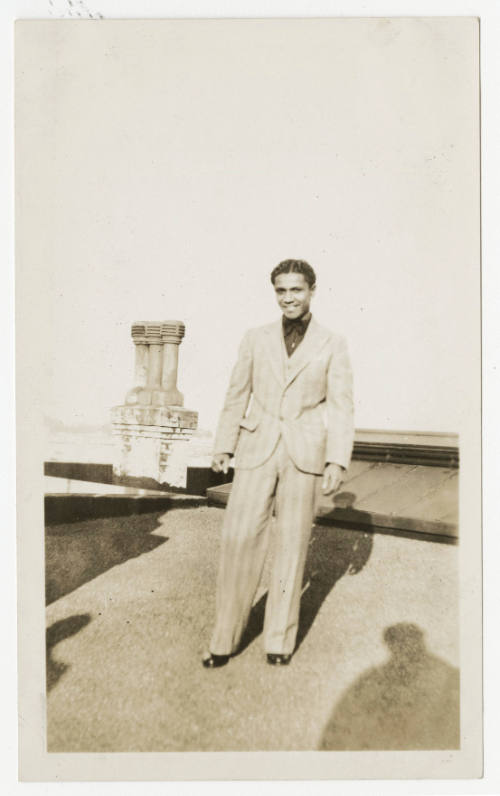 [Man standing on rooftop]