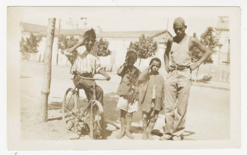 [Four boys standing on a sidewalk, St. Cloud, MN]