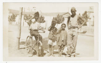 [Four boys standing on a sidewalk, St. Cloud, MN]